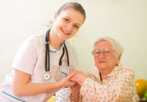 smiling caregiver with her old patient