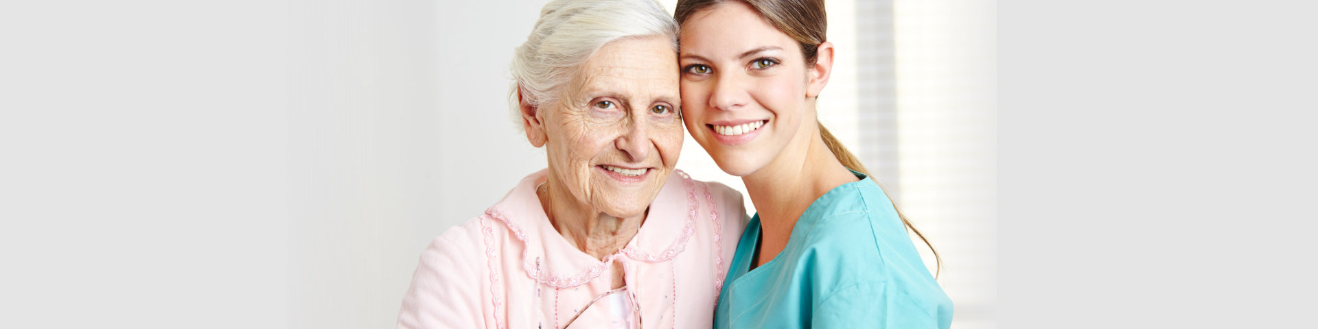 elderly woman with her caregiver smiling